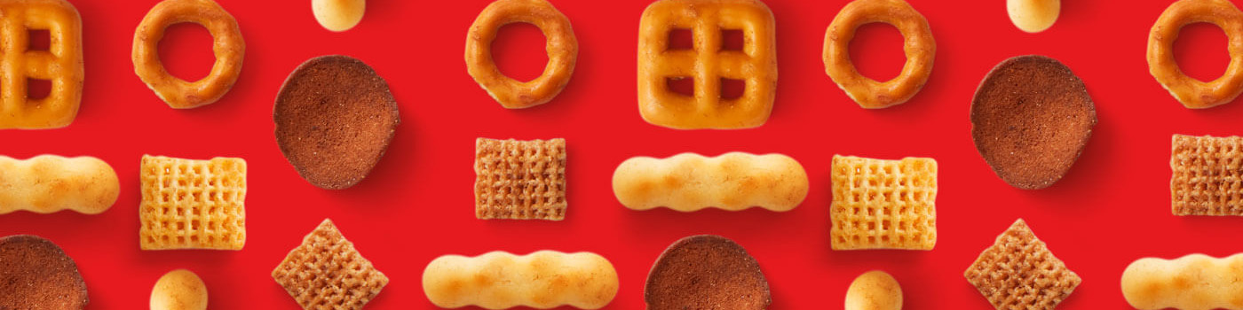 Chex Mix pieces in a pattern on a red background