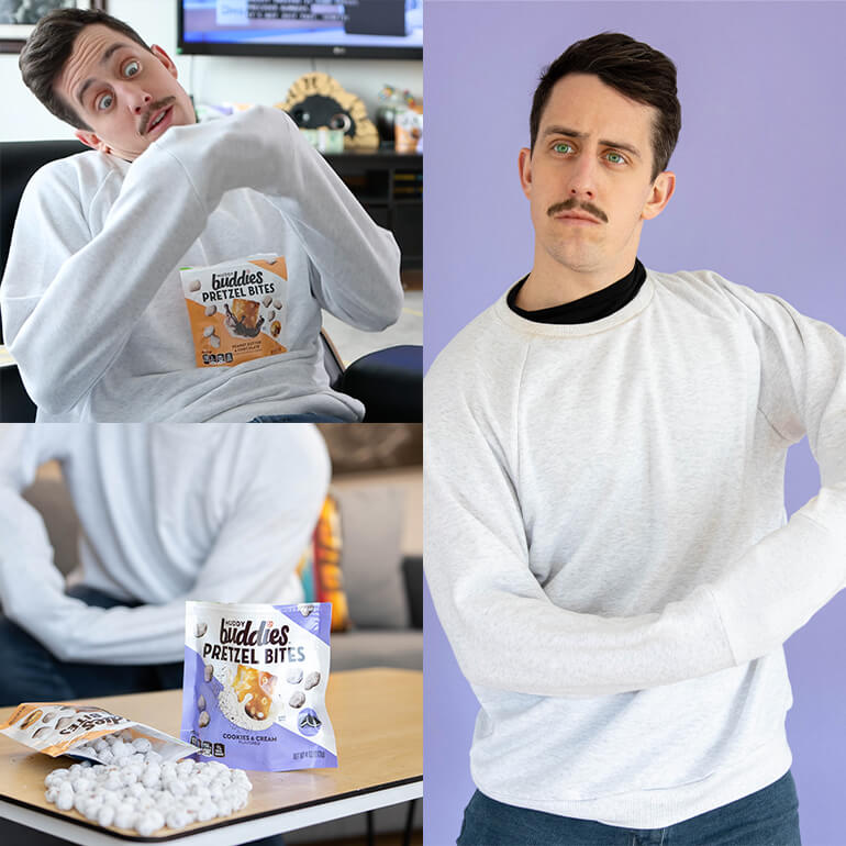 Man wearing the stop snacking sweater with Muddy Buddies Pretzel Bites nearby