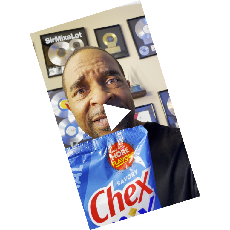 Sir Mix-A-Lot holding a bag of Chex Mix Traditional